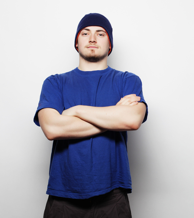 Life style, sport and people concept - young handsome man in blue t-shirt and blue hat.の写真素材
