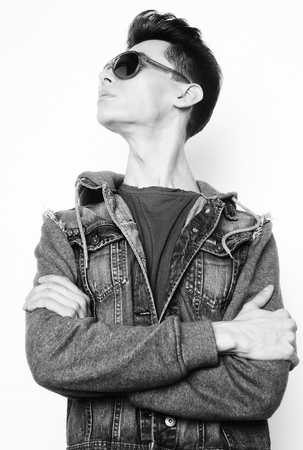 Fashion young man with fashionable sunglasses on white backgroundの写真素材