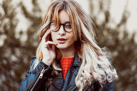 fashion hipster portrait of young beautiful blonde woman posing outdoor in summerの写真素材
