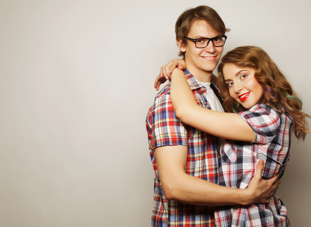 Couple in love.Young woman and man wearing casual wear over grey background.の写真素材