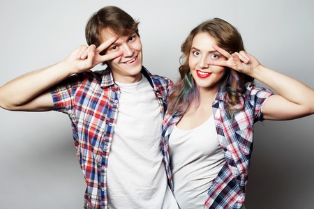 Couple in love.Young woman and man wearing casual wear over grey background.の写真素材