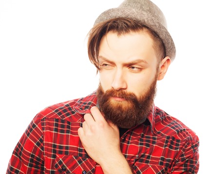 Young hipster man wearing hat. Studio shot over white background.の写真素材