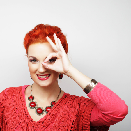 Pretty young woman looking for something with wide open eyes and imaginary binocular.の写真素材