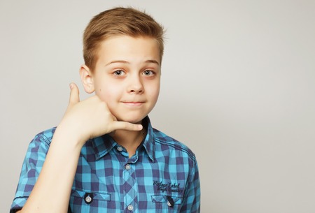 little boy in blue shirt over grey backgroundの写真素材