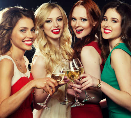 Group of partying girls clinking flutes with sparkling wine