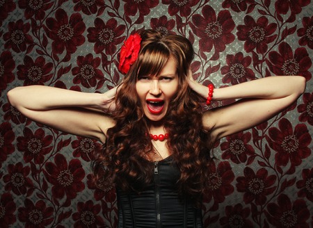 young beautiful girl with red flower in hairの写真素材