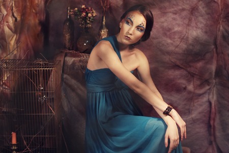 elegant sensual young woman in blue dressの写真素材