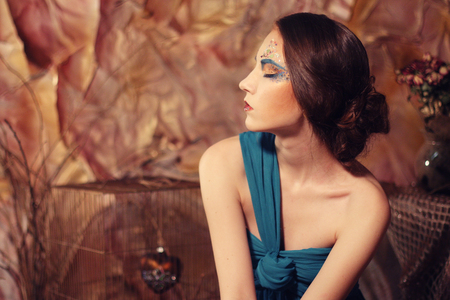 elegant sensual young woman in blue dressの写真素材