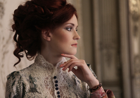 Young beautiful woman standing in the palace room. Young beautiful woman standing in the palace room.