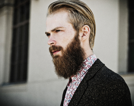 Portrait of young beautiful fashionable man outdoorの写真素材