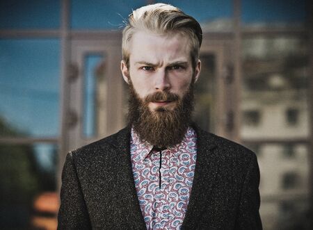 Portrait of young beautiful fashionable man outdoorの写真素材