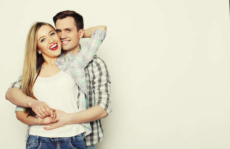 Love, family and people concept:  lovely happy  couple hugging  over white .