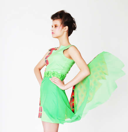 Fashion model in bright green dress over white backgroundの写真素材