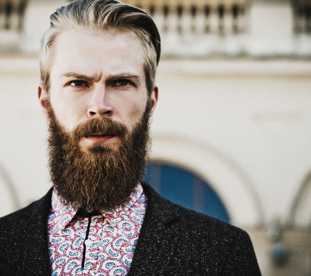 Portrait of young beautiful fashionable man outdoorの写真素材