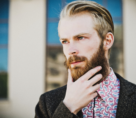 Portrait of young beautiful fashionable man outdoorの写真素材