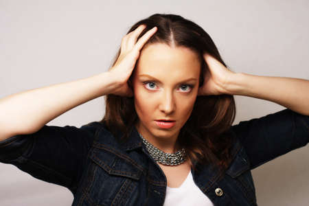 Beautiful young surprised woman. Studio shot.の写真素材