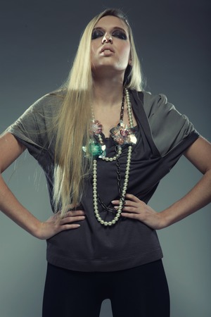 Studio shot of a young, beautiful, blond, fashionable womanの写真素材