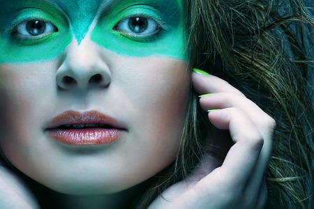 woman with green creative make-upの写真素材