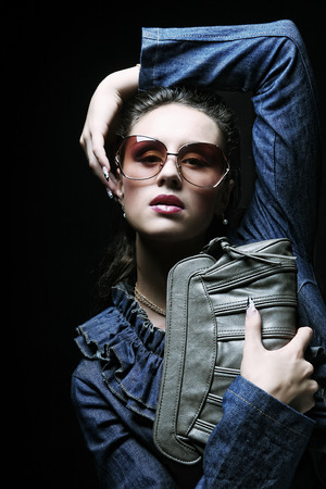 Beautiful fashion model with a bagの写真素材