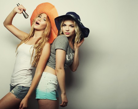 life style, happiness, emotional and people concept: two beauty girls with a microphone singing and having funの写真素材