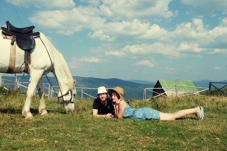 Young couple in love outdoor.Stunning sensual outdoor portrait of young couple posing in summer sunset near horse.の写真素材