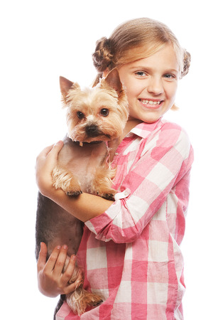 Portrait of an adorable young girl smiling holding Yorkshire Terrier puppyの写真素材
