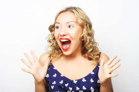 Beautiful young surprised blond woman. Studio shot.の写真素材