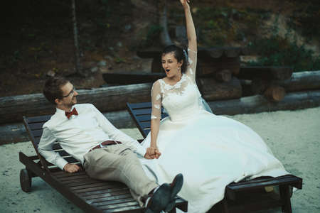 A young bride and groom standing together outdoor, summer timeの写真素材