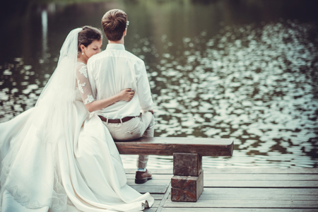 Honeymoon. The bride and groom hugging on the shore of Lake.の写真素材