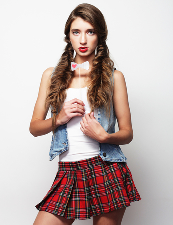 Lovely student girl wearing short skirt. On white background.の写真素材