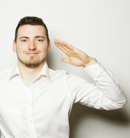 business, success and people concept - young business man wearing white shirt, isolated on white.の写真素材