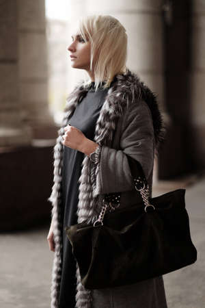 Stylish young blond woman wearing a winter lookの写真素材