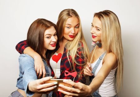 life style, happiness, emotional and people concept: funny girls, ready for party, selfieの写真素材