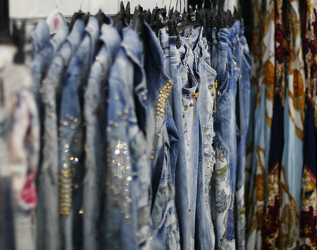Row of hanged blue jeans in a shopの写真素材