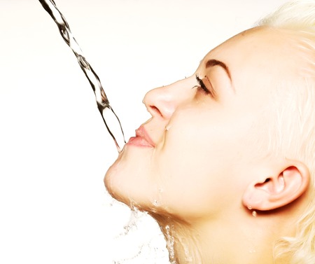 Young sensuality beautiful woman with clean skin with splash of water - white  backgroundの写真素材