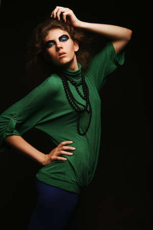 Fashion girl posing on dark backgroundの写真素材
