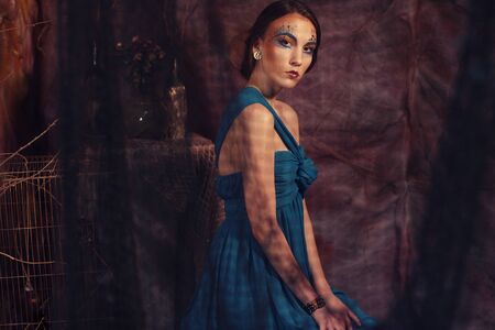 elegant sensual young woman in blue dressの写真素材