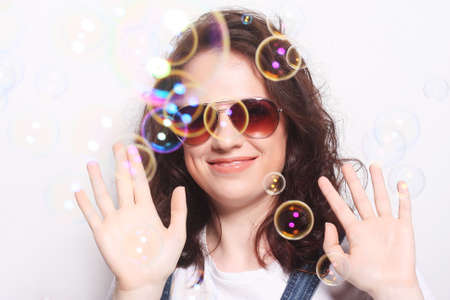 Young surprised woman wearing sunglasses. Emotional portrait.