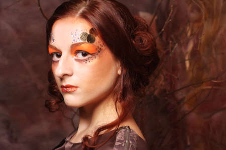 close up portrait redhair woman with bright creative make upの写真素材