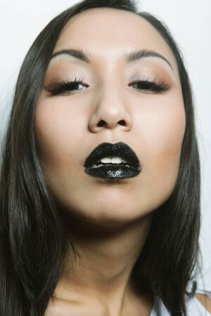 beautiful young asian woman with perfect skin and black  lipstick, fashion shootの写真素材