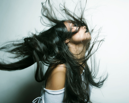 Fashion portrait of asian girl with hair lightly fluttering in the wind