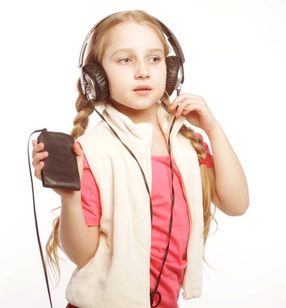 dancing little blond girl headphones music singing on white backgroundの写真素材