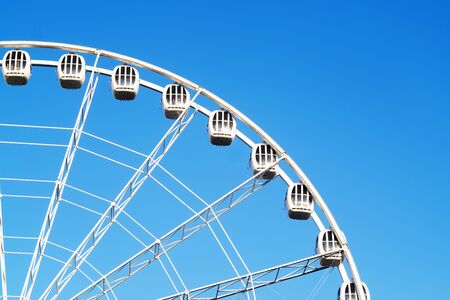 Ferris wheel on blue sky background