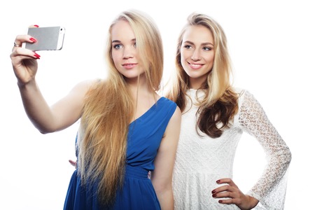 Pretty  girsl taking selfie. Isolated on white background.の写真素材