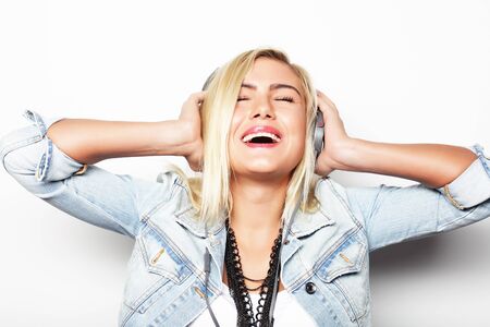 life style and people concept: Pretty young girl enjoys listening musicの写真素材