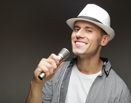 life style and people concept: young singer man with microphoneの写真素材