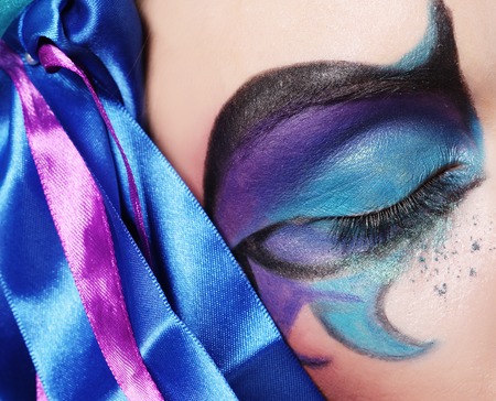 Macro close-up of beautiful female eye with bright creative make-upの写真素材