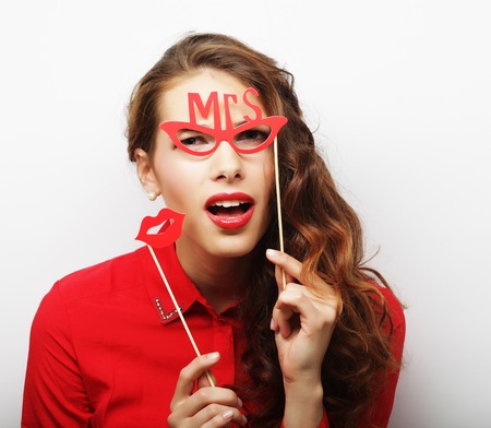 Party image. Playful young woman holding a party glasses.の写真素材