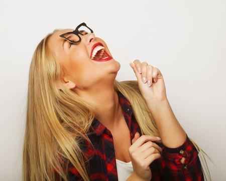 Party image.Young woman holding a party glasses. Over white background.の写真素材