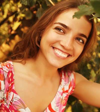 Pretty cheerful woman in the gardenの写真素材